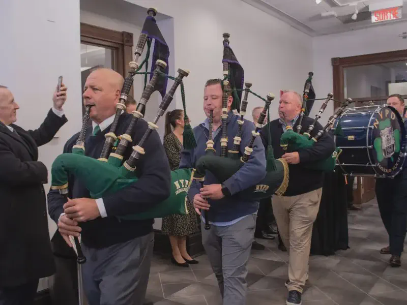 Pipers and drummers parade through City Hall at pre-parade reception