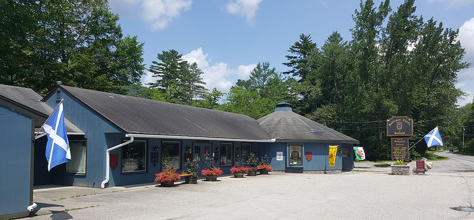 Rablogan Castle of Scotland storefront in Arlington, Vermont, with Scottish flags.
